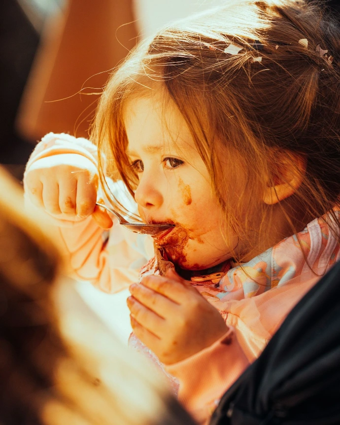 a woman eating a piece of food